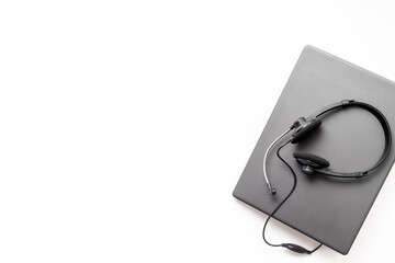 VOIP headset on laptop, top view. IT support, call center and customer service help desk concept