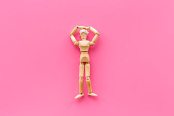 Wooden figurine of a man head wrapped in bandage - concussion or head injury