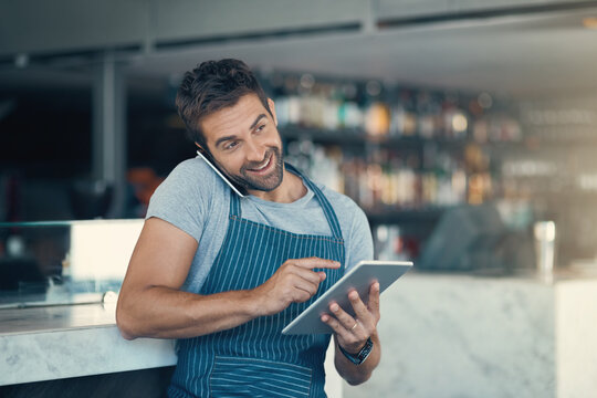 Happy man, waiter and phone call with tablet for reservation, online booking or order at cafe. Male person or barista talking with smile, technology or mobile smartphone for service at restaurant