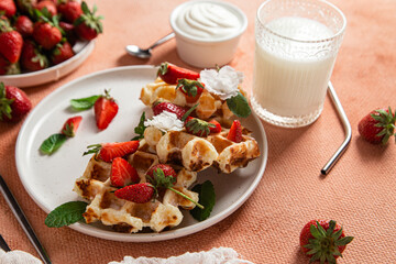 Belgian waffles with fresh strawberries in a plate. Viennese waffles