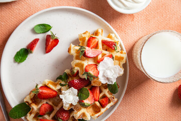 Belgian waffles with fresh strawberries in a plate. Viennese waffles