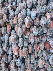 Fresh Plums Piled at Local Market