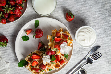 Belgian waffles with fresh strawberries in a plate. Viennese waffles