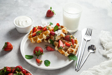 Belgian waffles with fresh strawberries in a plate. Viennese waffles