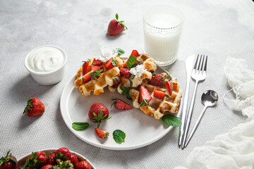Belgian waffles with fresh strawberries in a plate. Viennese waffles