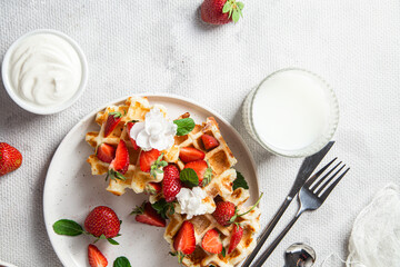 Belgian waffles with fresh strawberries in a plate. Viennese waffles