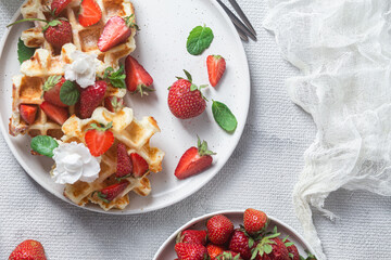 Belgian waffles with fresh strawberries in a plate. Viennese waffles