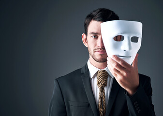 Portrait, business man and spy with mask in studio isolated on gray background. Fake face, suit and industrial espionage disguise of agent with rope noose for secret identity, confidential or fraud