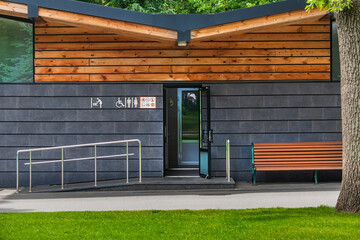 Modern city toilet in a park or city garden. Exterior of a public toilet