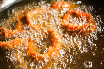 calamari rings being cooked in hot oil
