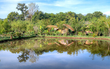 Obraz premium Wooden house by the lake. Dreamy morning scene, relaxing and quiet time