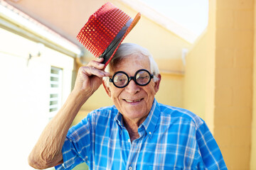 Face, smile and glasses with senior man in hallway of retirement home for goofy party on weekend....