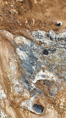 Impressive geothermal area Hverir Island with its smoke columns, red Mars-like soil and moon-like craters, mountains and hot black areas