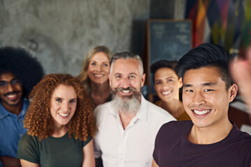 Fototapeta premium Designer people, happy and selfie in portrait in office of creative agency, memory and smile for company photograph. Group, team and diversity, together and photography for business website profile.