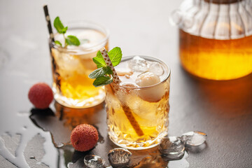 Lychee iced tea with mint leaves in drinking glass. Refreshment drink