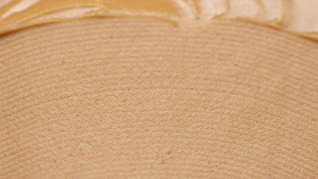 Peanut Butter Spreading with a golden knife, close up