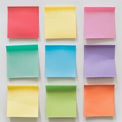 Naklejka premium A grid of nine square sticky notes in assorted colors (red, blue, green, yellow, purple) on a white background. 