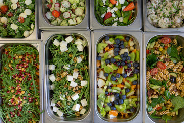 Salads in metal containers, top view