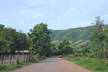 Paved roads wind through bright green landscapes dotted with trees.