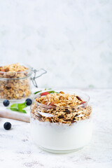Granola with yogurt and fresh berries. Healthy breakfast of oat muesli