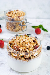 Granola with yogurt and fresh berries. Healthy breakfast of oat muesli