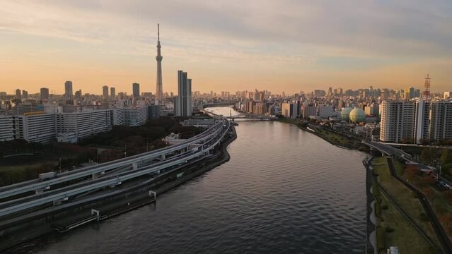 tokyo city skyline aerial view drone skytree tower district from arakawa river at sunrise,big highway on riverside
