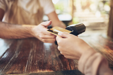 Hand, credit card and pos terminal in coffee shop for payment by customer for waitress service....