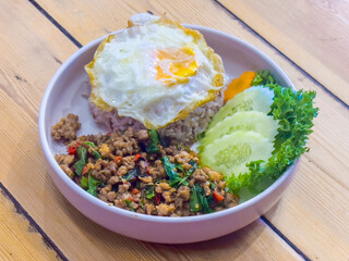 Authentic Thai Basil Chicken Recipe is Stir fried Thai basil with minced pork or chicken served with a fried egg and cooked rices.