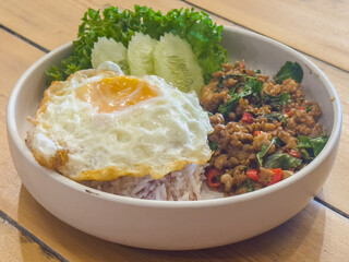 Authentic Thai Basil Chicken Recipe is Stir fried Thai basil with minced pork or chicken served with a fried egg and cooked rices.