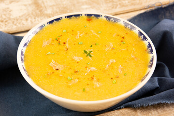 Pumpkin shredded chicken breast soup with herbs and spices