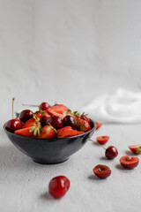 Blue plate with fresh fruit, on a light, white background