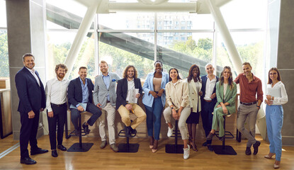 Team of happy diverse people meeting at professional business event. Group portrait smiling young...