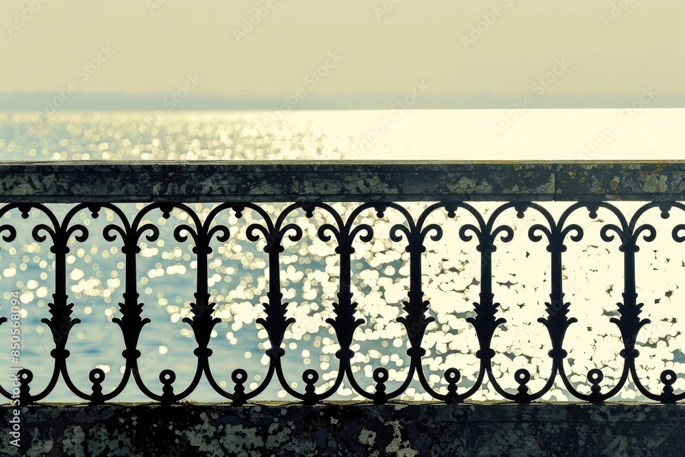 Poster a close-up view of a black iron fence surrounding a calm lake