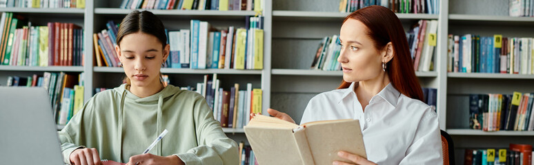 A tutor with red hair teaches a teenage girl in a library among tall bookcases, with a laptop open for modern education.