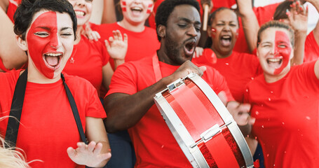 Sport fans screaming while supporting their team at stadium during euro competition - Football...