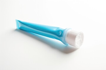 A tube of toothpaste placed on a clean and plain white surface, ideal for use in e-commerce, advertising or editorial purposes