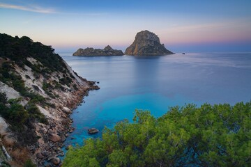 Fototapeta premium view of the landmark Es Vedra island and rocks off the coast of Ibiza at sunrise