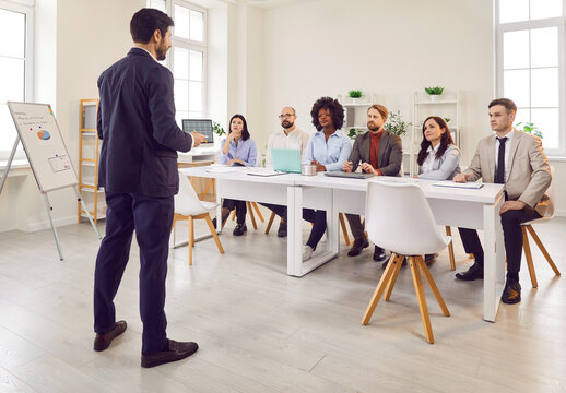 Chief conducts a work meeting for a group of office workers, communication and teamwork. Effective leadership and collaboration among the business people team in a professional office environment.