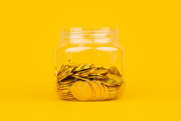 Gold coins on a yellow background, investing in gold Stock market and financial growth