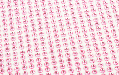 Pink rhinestones on a white background