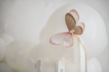 Paper pink decor butterfly. Birthday party for baby girl on a background photo wall. Arch...