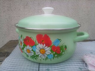 green saucepan painted with flowers