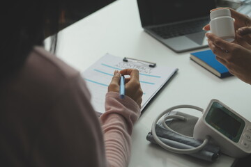 Doctor and patient discussing something while sitting at the table . Medicine and health care concept. Doctor and patient