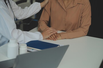 Hand of doctor reassuring her female patient