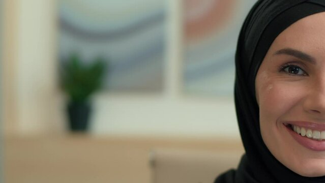 Close up half face portrait muslim islamic woman hijab happy businesswoman smiling toothy smile laugh cheerful girl ethnic Arabian female business employer arabic lady islam beauty health copy space
