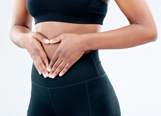 Woman, hands and stomach health in studio with digestion, progress and detox diet for gut wellness....