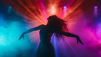 A woman is dancing in front of a colorful light show