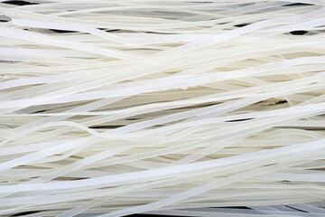 Dried uncooked rice noodles. Raw rice flour noodles