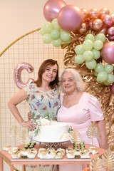 portrait of a person, family celebrating new year, mother and daughter at birthday party, mother and daughter holding hands, women at party, mother's day, grandmother's day, birthday party
