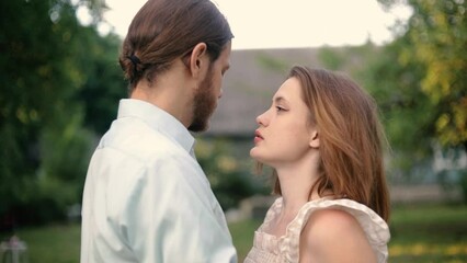 couple in love near the house in the yard rejoice and hug